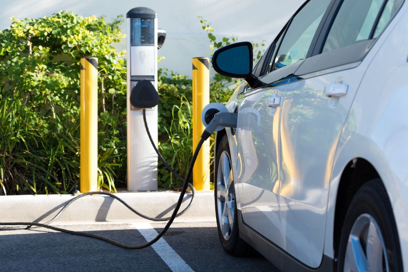 photo of an EV Electric Vehicle charging in parking lot