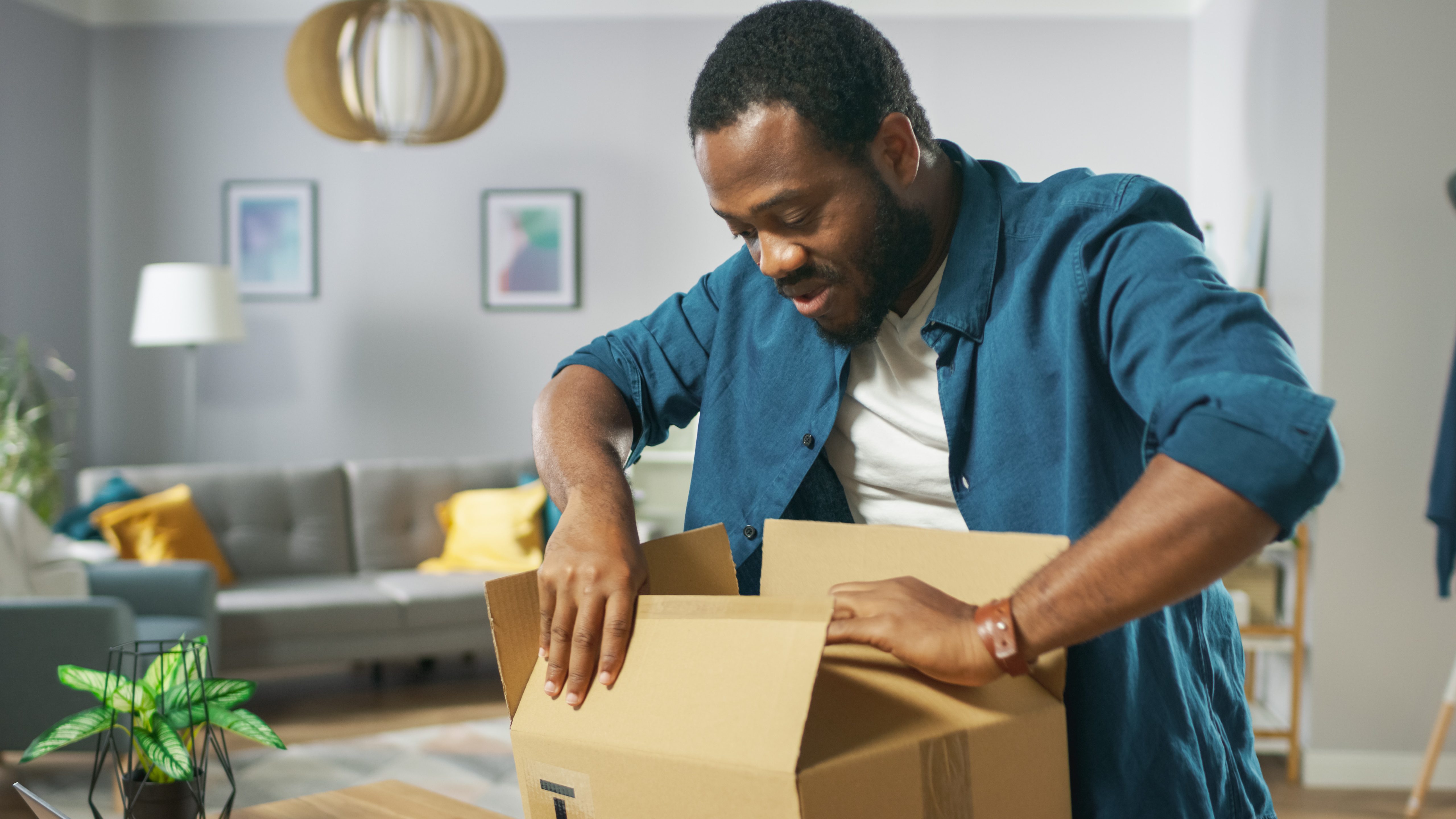 man closing box and getting it ready for shipping