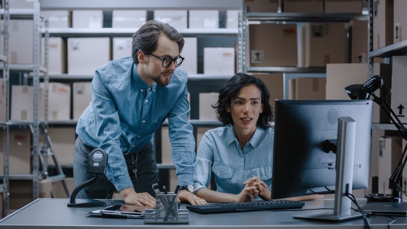 Employees looking at computer to review packaging designs