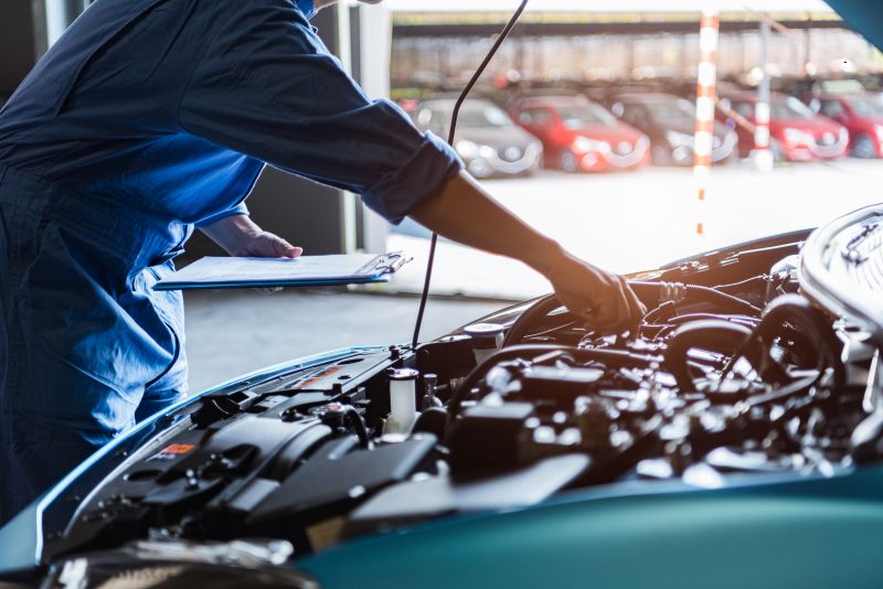 Mechanic working on car engine