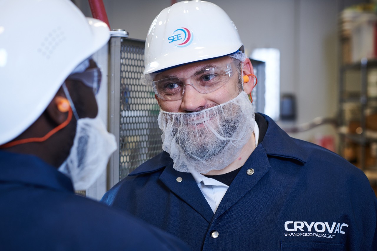 Cryovac service technician in white hard hat and blue shirt